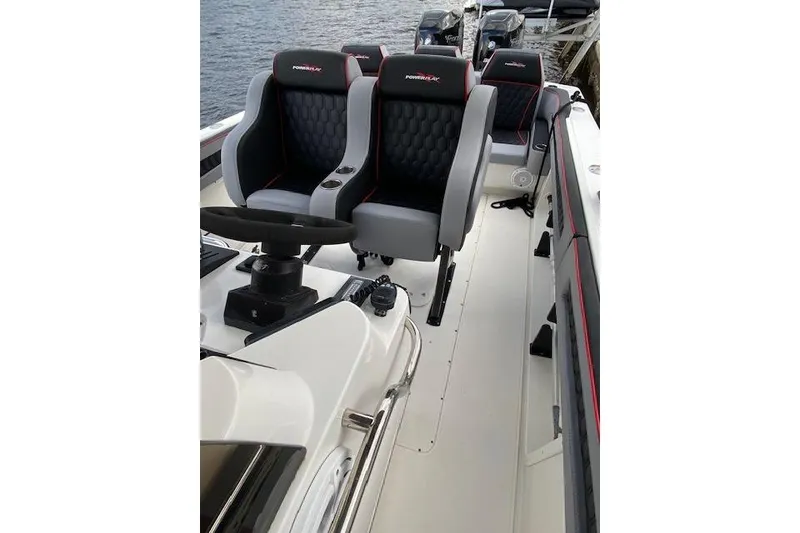 Slide: The Image of 1996 Powerplay Powerboats 33 Sportfish interior with modern seating and steering wheel. - 9