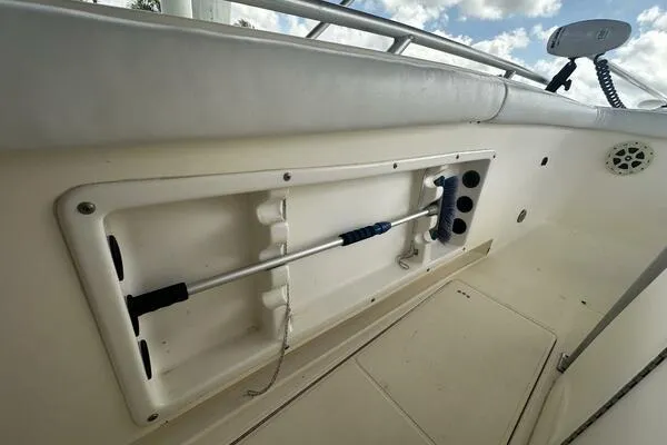 Slide: The Image of 2004 World Cat 270 TE Tournament Edition boat interior with storage compartment and rod holder. - 10