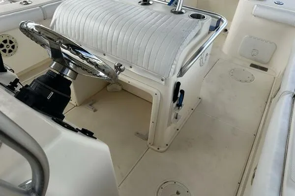 Slide: The Image of 2004 World Cat 270 TE Tournament Edition boat interior with steering wheel and seating. - 23