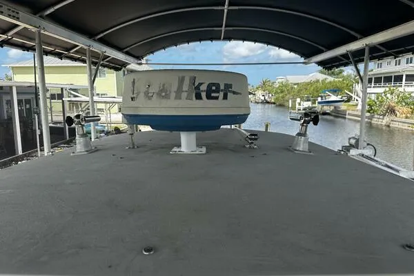 Slide: The Image of 2004 World Cat 270 TE Tournament Edition boat with radar, docked under canopy. - 26