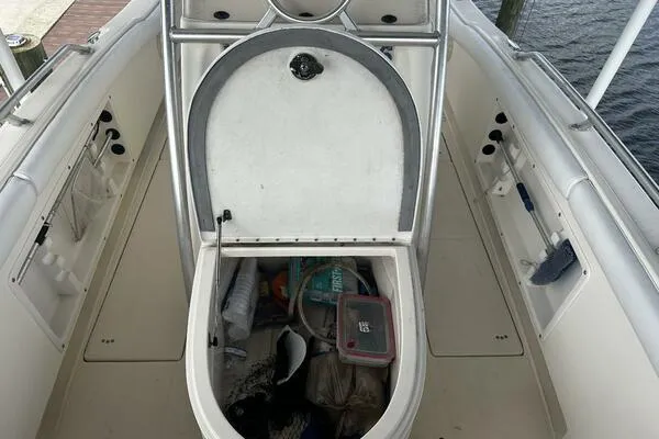 Slide: The Image of 2004 World Cat 270 TE Tournament Edition boat storage compartment open, showing various items inside. - 27