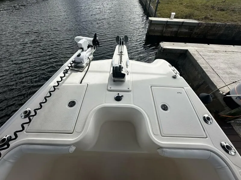 Slide: The Image of 2004 World Cat 270 TE Tournament Edition boat bow with fishing equipment, docked by the water. - 3