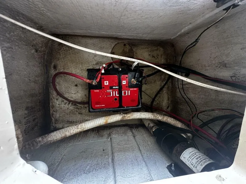 Slide: The Image of 2004 World Cat 270 TE boat battery compartment with wiring and components. - 31