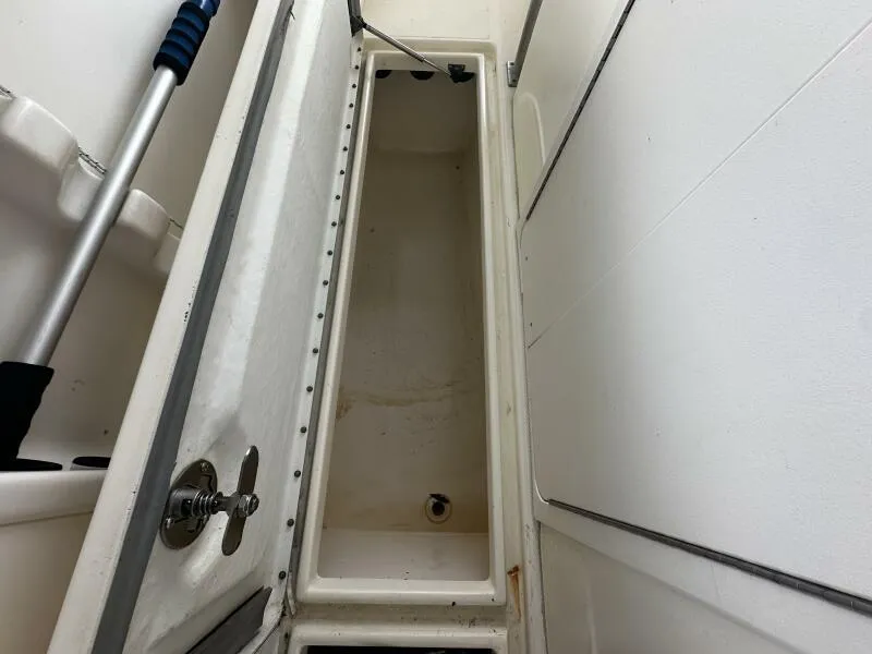 Slide: The Image of 2004 World Cat 270 TE Tournament Edition boat storage compartment interior. - 35