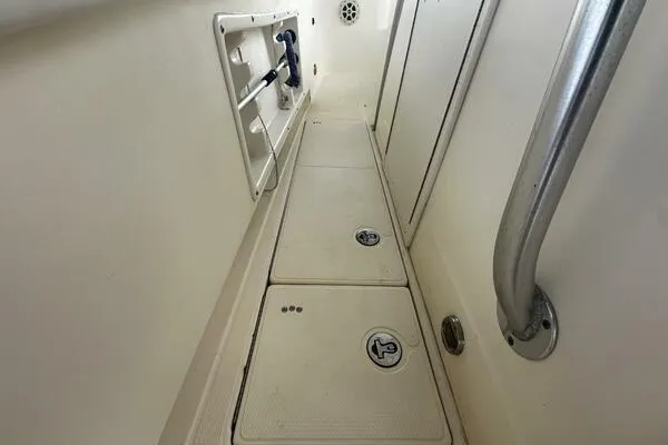 Slide: The Image of 2004 World Cat 270 TE Tournament Edition boat interior with storage compartments and railing. - 37