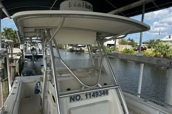 Slide: The Image of 2004 World Cat 270 TE Tournament Edition boat docked by a canal. - 4