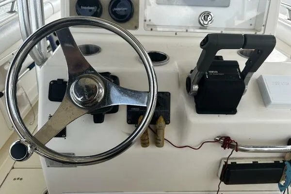 Slide: The Image of 2004 World Cat 270 TE boat helm with steering wheel and controls. - 41