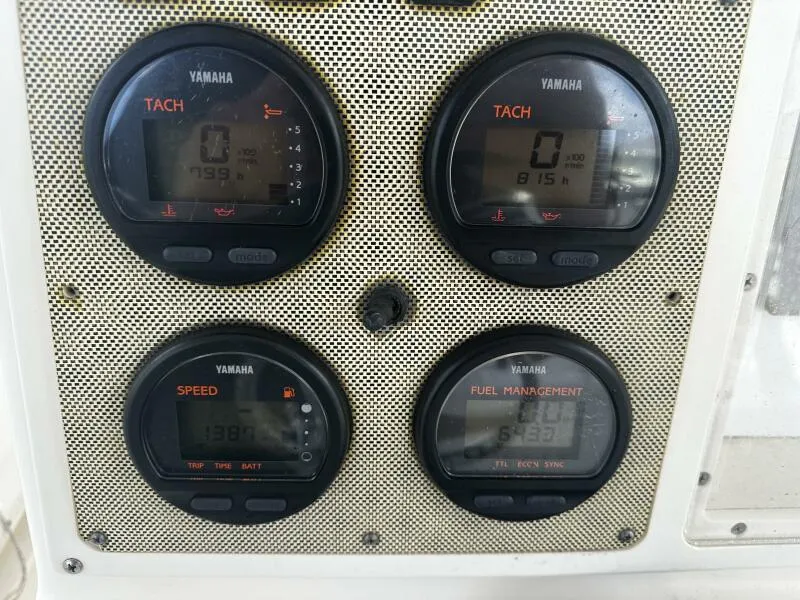 Slide: The Image of Yamaha gauges on a 2004 World Cat 270 TE Tournament Edition boat dashboard. - 43