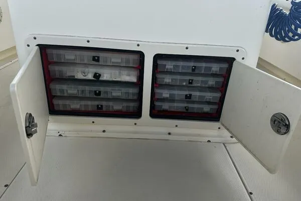 Slide: The Image of 2004 World Cat 270 TE Tournament Edition tackle storage compartments with open doors. - 47