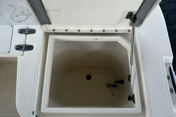 Slide: The Image of Open storage compartment on 2004 World Cat 270 TE Tournament Edition boat. - 49