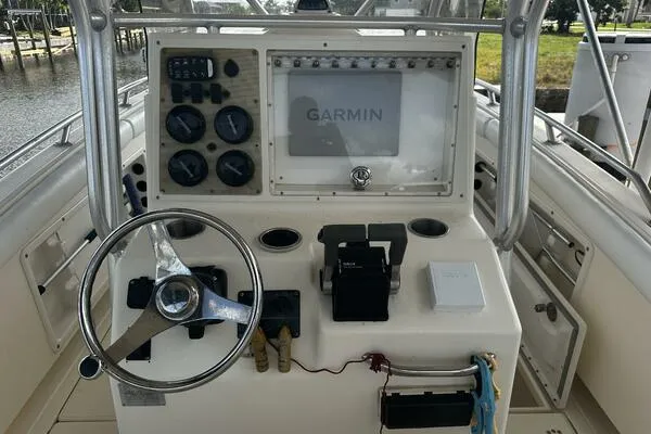 Slide: The Image of 2004 World Cat 270 TE boat console with Garmin navigation system and steering wheel. - 5