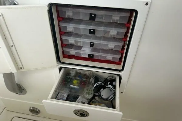 Slide: The Image of Tackle storage on 2004 World Cat 270 TE Tournament Edition boat, featuring organized fishing gear. - 7