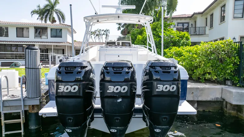 Slide: The Image of 2008 Intrepid 370 Cuddy with triple 300 horsepower engines docked by waterfront homes. - 12