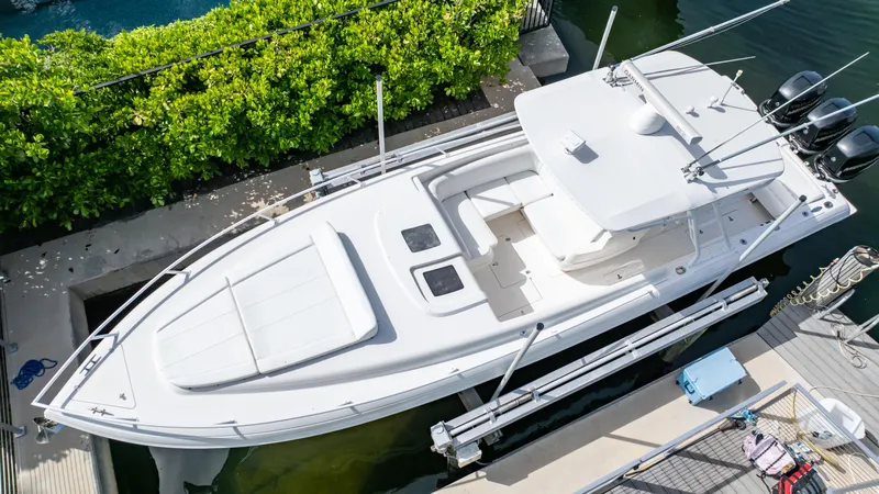 Slide: The Image of 2008 Intrepid 370 Cuddy boat docked, aerial view, sleek design, white exterior. - 14