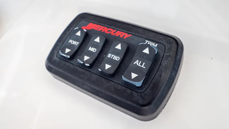 Slide: The Image of Mercury trim control panel for Intrepid 370 Cuddy, 2008 model, featuring port, mid, starboard buttons. - 25