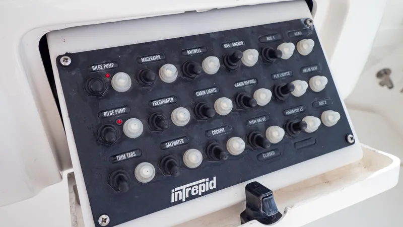 Slide: The Image of Control panel of a 2008 Intrepid 370 Cuddy boat with labeled switches. - 27