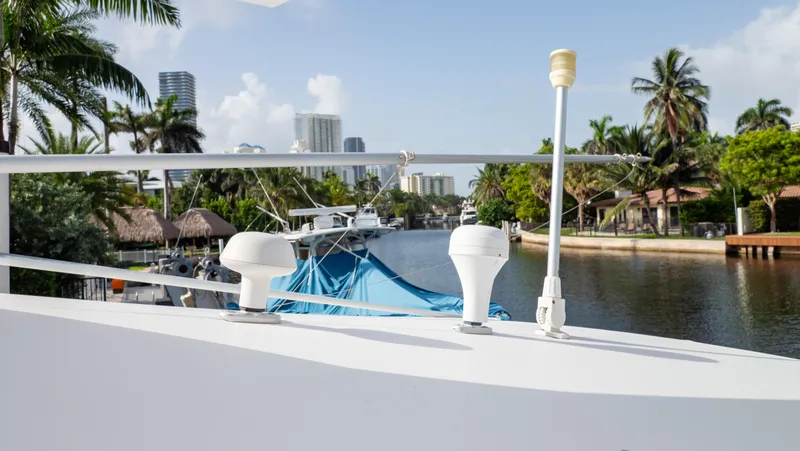 Slide: The Image of 2008 Intrepid 370 Cuddy boat docked by a scenic canal with palm trees. - 32