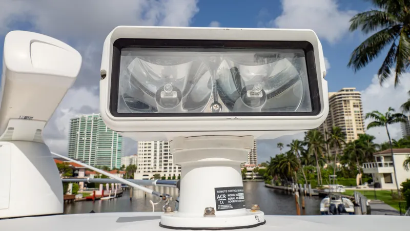 Slide: The Image of Close-up of a 2008 Intrepid 370 Cuddy spotlight with a waterfront cityscape background. - 34