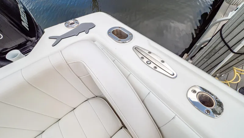 Slide: The Image of 2008 Intrepid 370 Cuddy boat interior with white seating and stainless steel fixtures. - 48