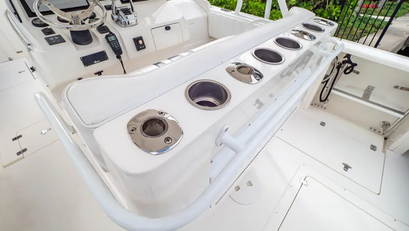 Slide: The Image of 2008 Intrepid 370 Cuddy boat interior with rod holders and control panel. - 49