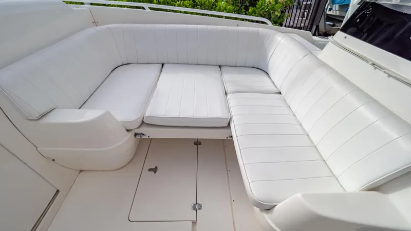 Slide: The Image of 2008 Intrepid 370 Cuddy boat with white cushioned seating area. - 6