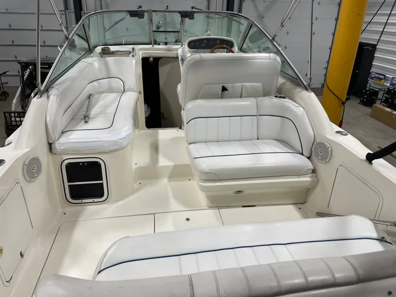 Slide: The Image of 1995 Sea Ray 270 Sundancer boat on trailer in indoor storage facility. - 1