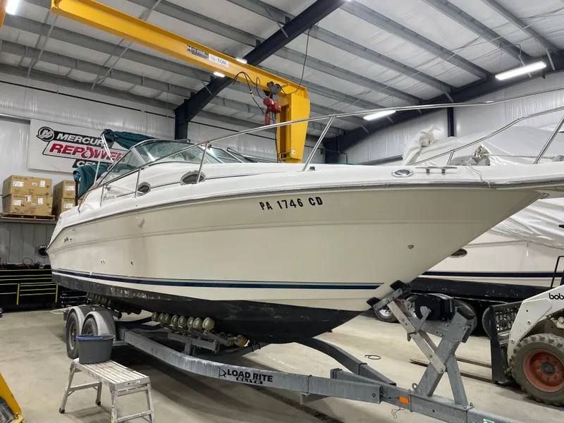 Slide: The Image of 1995 Sea Ray 270 Sundancer boat on trailer in indoor storage facility. - 2