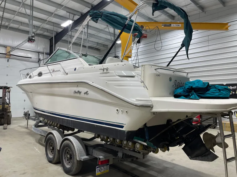 Slide: The Image of 1995 Sea Ray 270 Sundancer boat on trailer in indoor storage facility. - 3