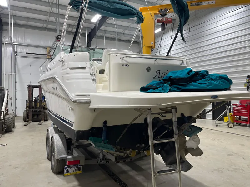 Slide: The Image of 1995 Sea Ray 270 Sundancer boat on trailer in indoor storage facility. - 4