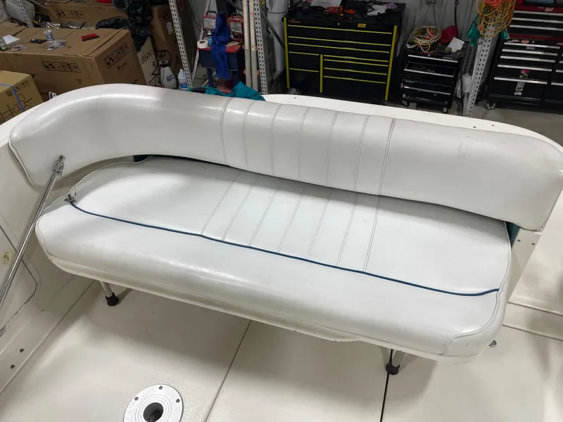 Slide: The Image of White leather seating on a 1995 Sea Ray 270 Sundancer boat, in a workshop setting. - 7