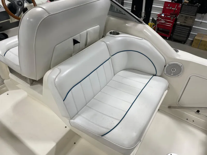 Slide: The Image of 1995 Sea Ray 270 Sundancer cabin interior with storage and seating area. - 8