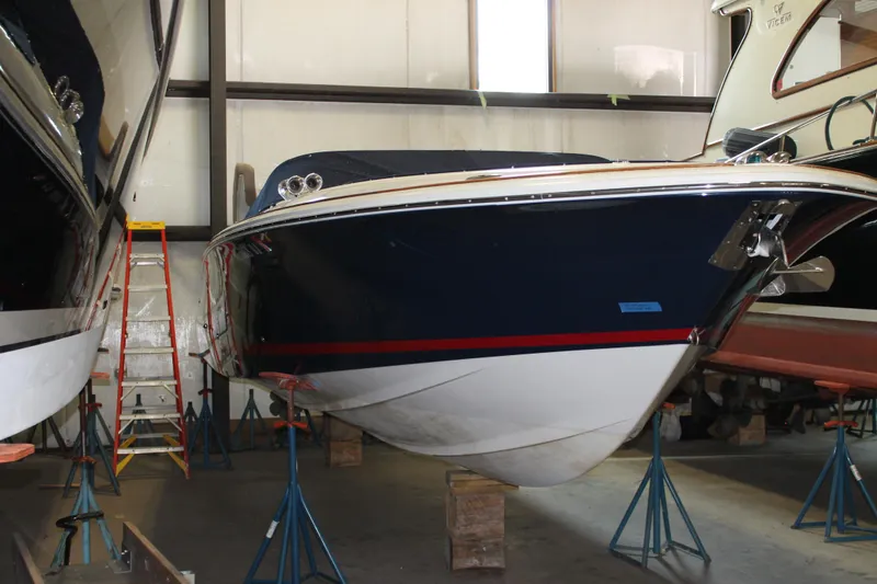 Slide: The Image of 2007 Chris-Craft Launch 28 boat in storage, elevated on stands in a warehouse. - 1