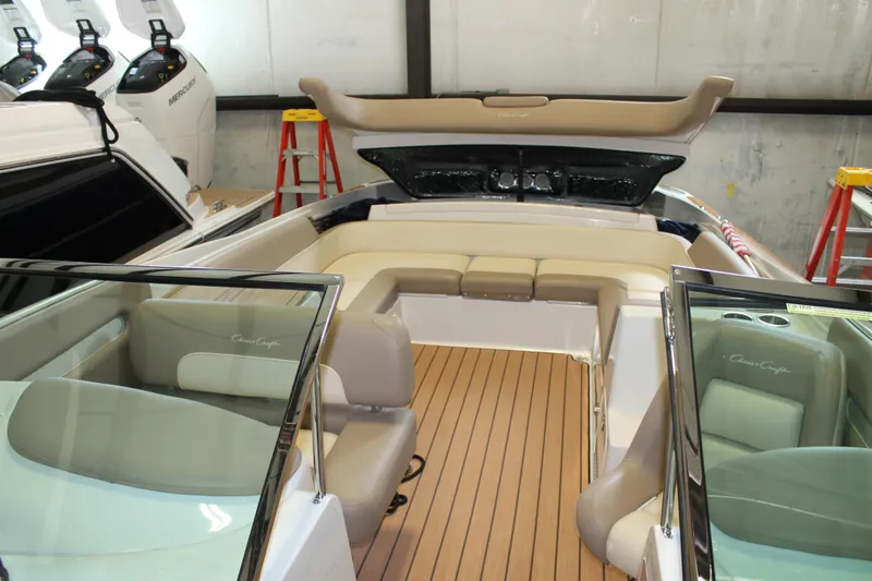 Slide: The Image of 2007 Chris-Craft Launch 28 boat interior with beige seating and wooden flooring. - 11