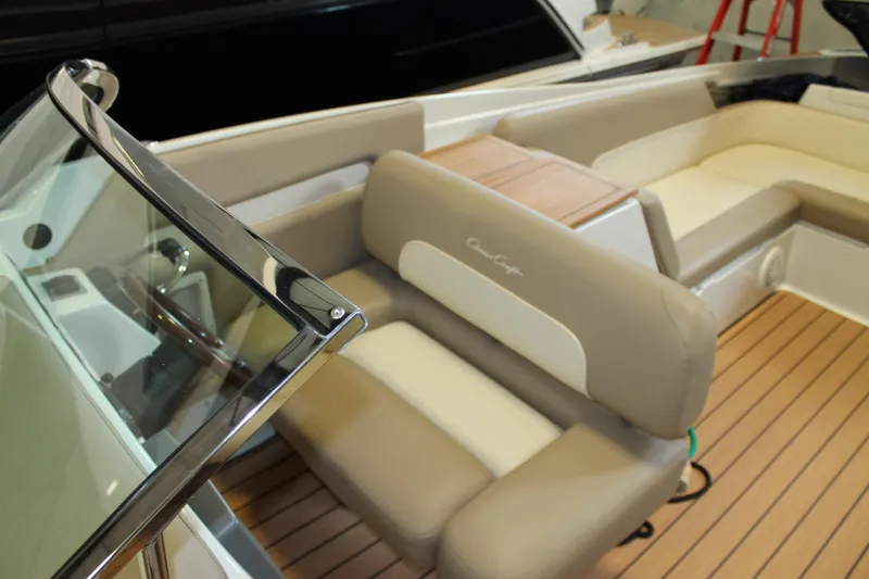 Slide: The Image of 2007 Chris-Craft Launch 28 boat interior with beige seating and wooden deck. - 12