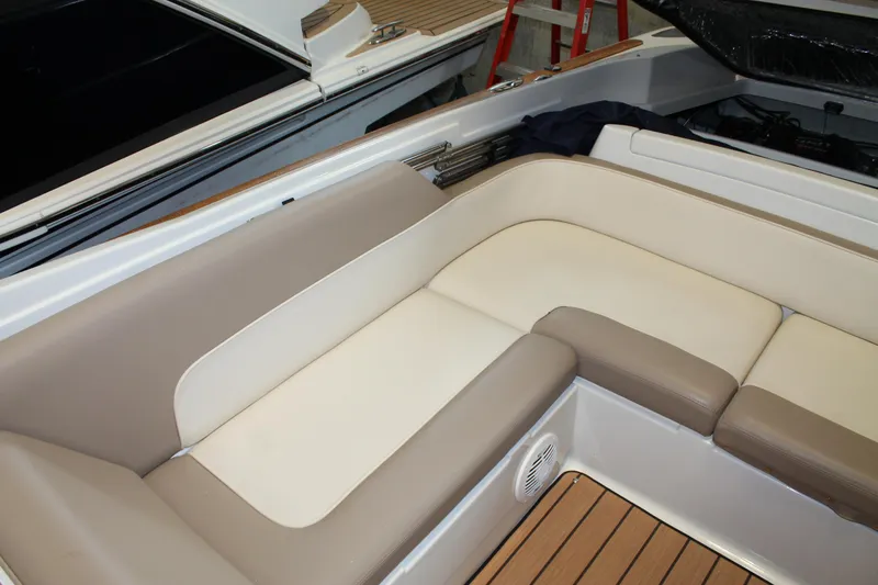 Slide: The Image of 2007 Chris-Craft Launch 28 boat interior with beige seating and wooden flooring. - 15