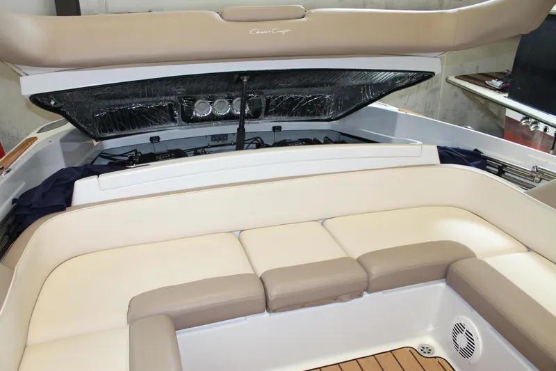 Slide: The Image of 2007 Chris-Craft Launch 28 boat interior with beige seating and open engine compartment. - 17