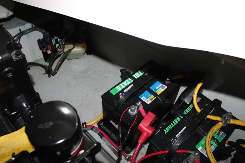 Slide: The Image of Battery compartment of a 2007 Chris-Craft Launch 28 boat with wiring and components. - 22