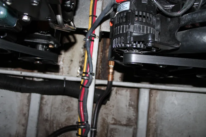 Slide: The Image of Engine compartment of a 2007 Chris-Craft Launch 28, showing belts and wiring. - 23