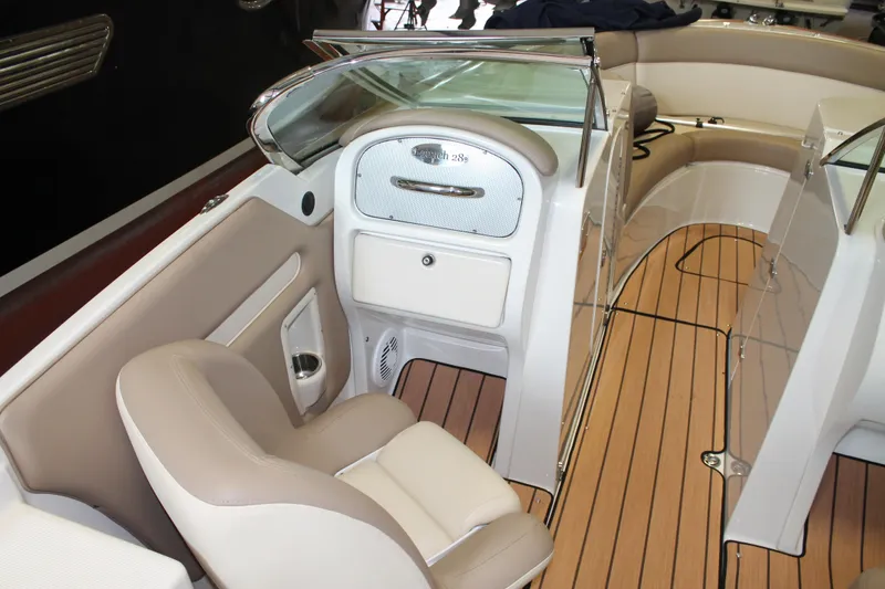 Slide: The Image of 2007 Chris-Craft Launch 28 interior with beige seating and wooden flooring. - 24