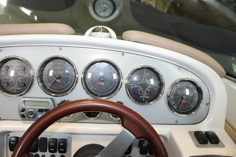 Slide: The Image of Dashboard of 2007 Chris-Craft Launch 28 boat with gauges and wooden steering wheel. - 27