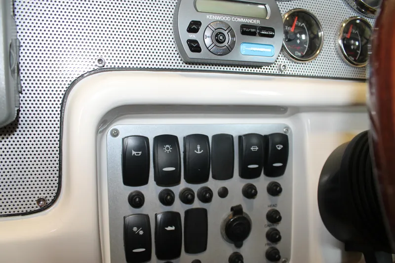 Slide: The Image of Control panel of 2007 Chris-Craft Launch 28 boat with switches and gauges. - 28