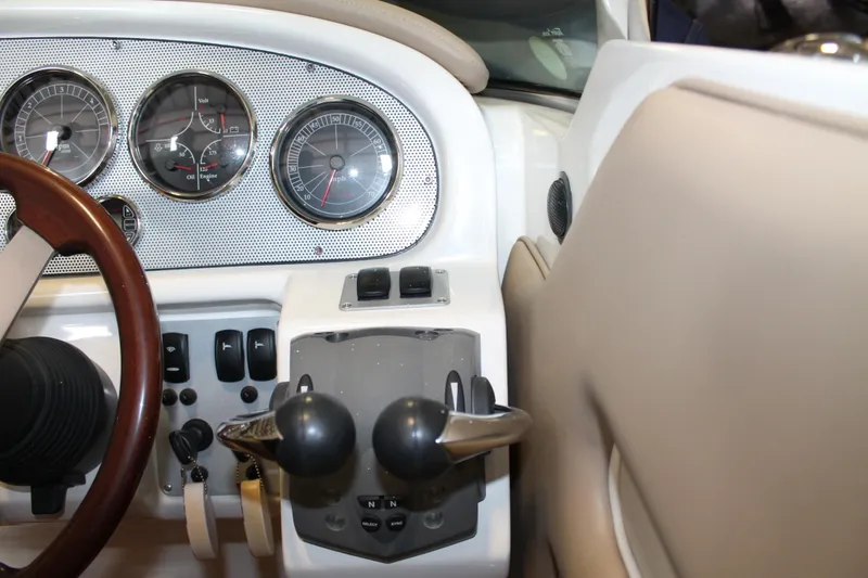 Slide: The Image of 2007 Chris-Craft Launch 28 dashboard with gauges and controls, featuring a wooden steering wheel. - 29