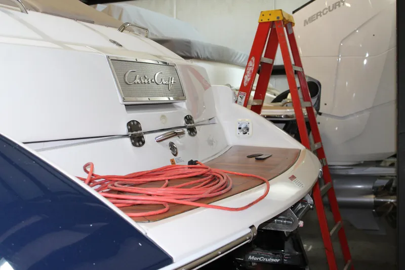 Slide: The Image of 2007 Chris-Craft Launch 28 boat in storage, with red ladder and coiled rope on deck. - 6