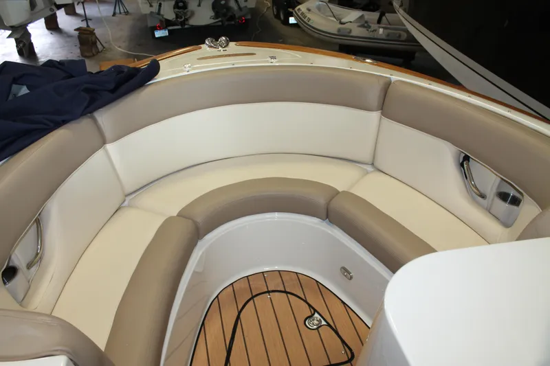 Slide: The Image of 2007 Chris-Craft Launch 28 boat interior with cushioned seating and wooden flooring. - 8