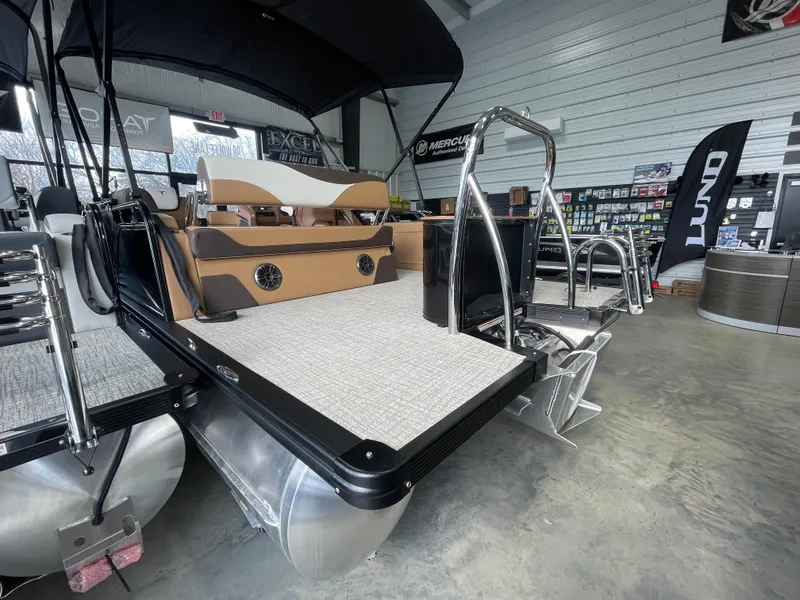 Slide: The Image of 2025 Tahoe Pontoon 2185 LTZ in showroom, featuring sleek design and modern amenities. - 3