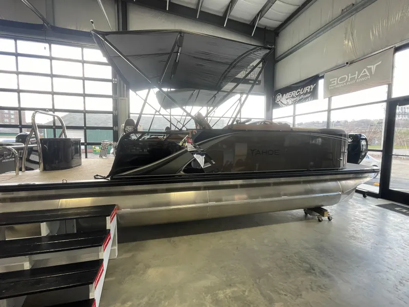 Slide: The Image of 2025 Tahoe Pontoon 2185 LTZ in showroom, featuring sleek design and modern canopy. - 5
