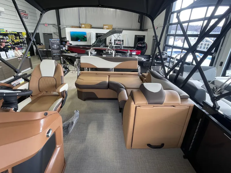 Slide: The Image of 2025 Tahoe Pontoon 2185 LTZ interior with beige seating and stainless steel fixtures. - 6