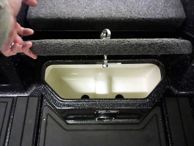 Slide: The Image of 2024 Ranger 622FS Pro DC boat storage compartment with open lid, showcasing interior space. - 11