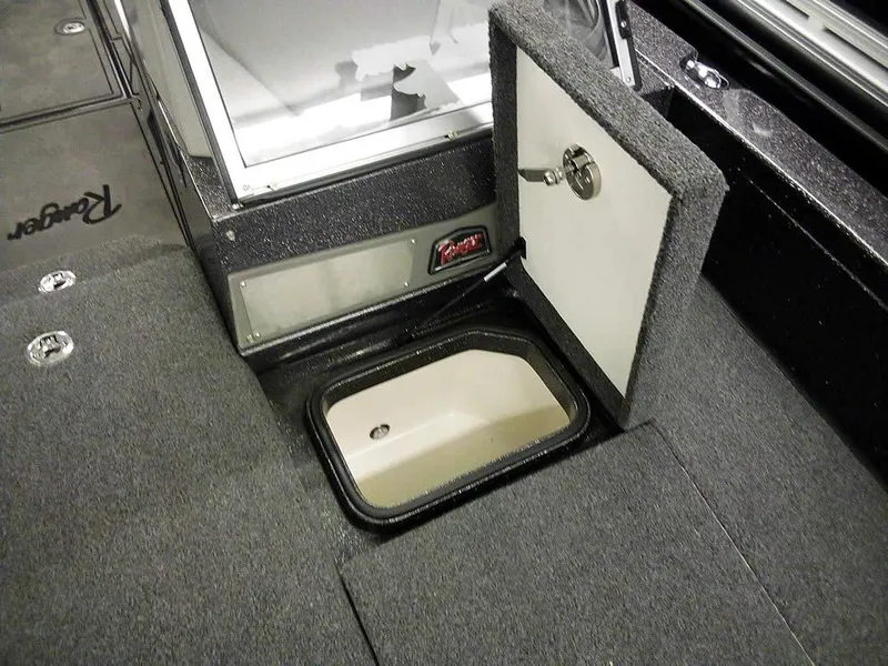 Slide: The Image of 2024 Ranger 622FS Pro DC boat storage compartment with open hatch, showcasing interior design. - 15