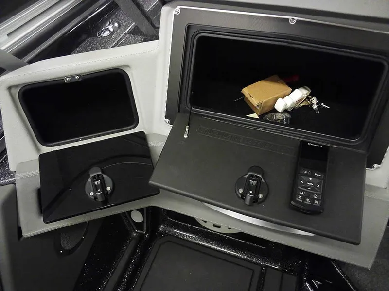 Slide: The Image of 2024 Ranger 622FS Pro DC boat storage compartments with keys and remote control. - 23